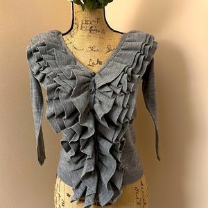 Sinclaire baby wool knit sweater with front ruffle detail.